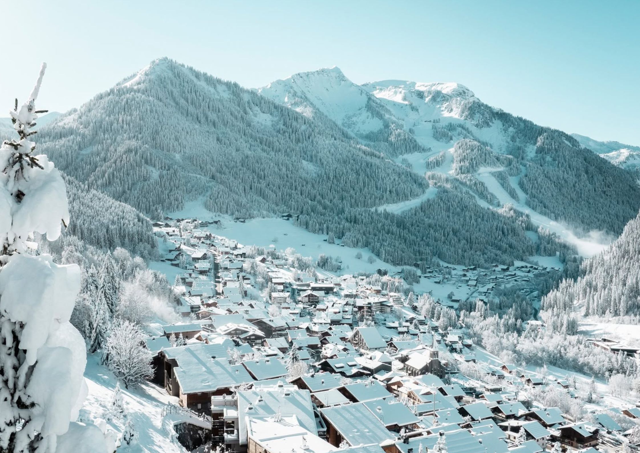 Chatel village from above in winter with traditional alpine chalets and Super-Chatel ski slopes behind