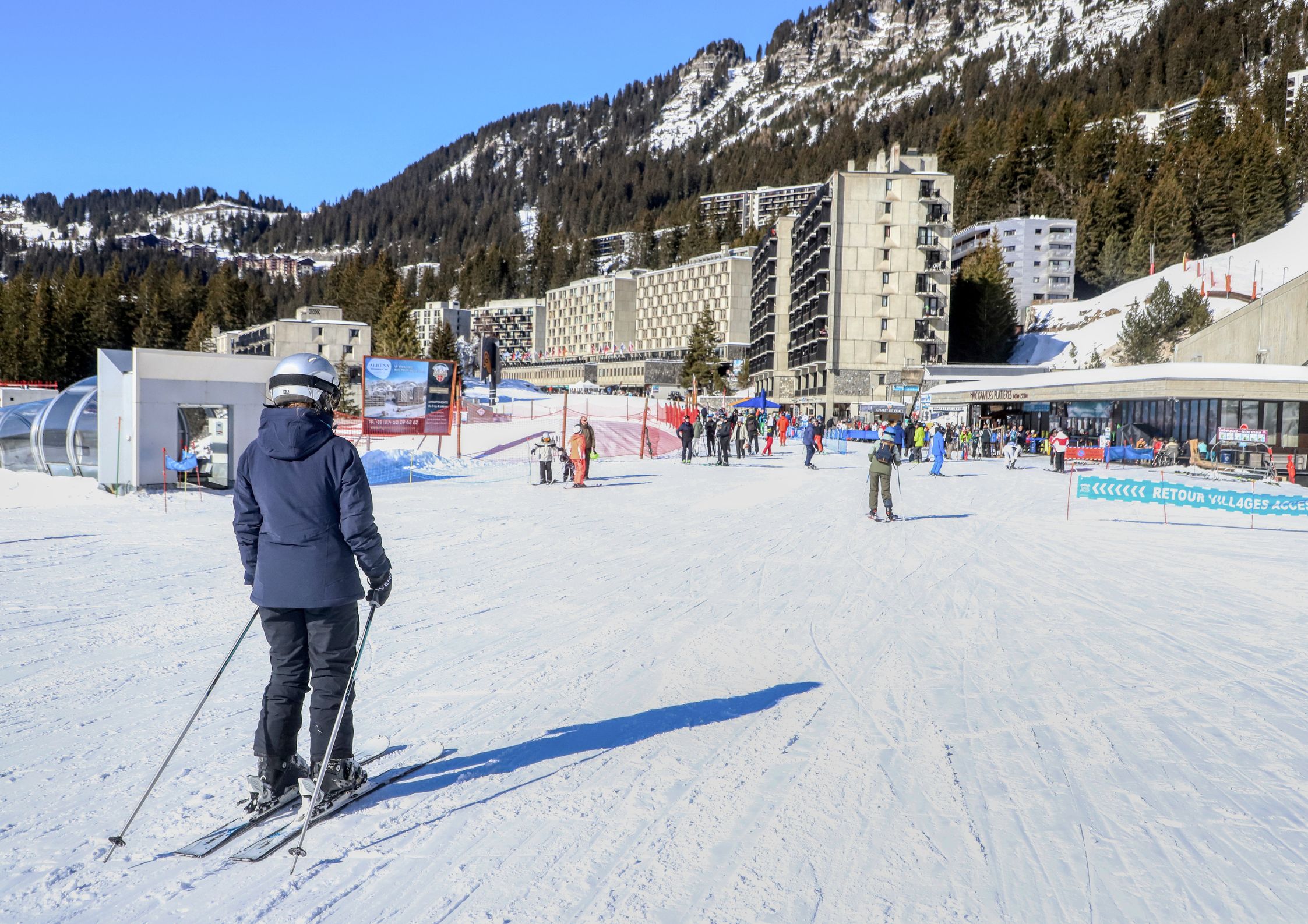 kier arriving at Flaine Forum resort centre with ski-in ski-out access and Bauhaus apartment buildings behind