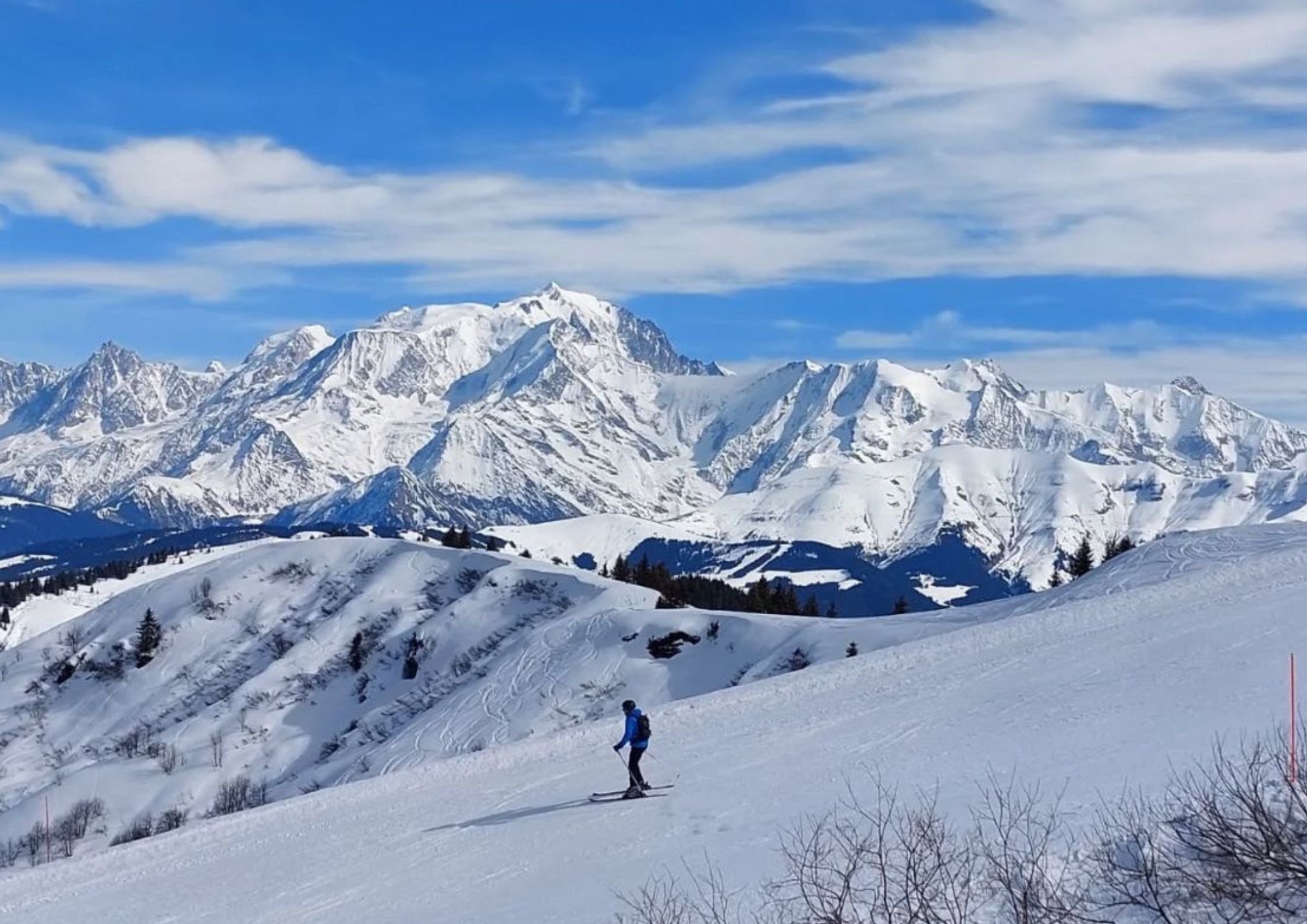 Skier on the slopes above La Giettaz with panoramic views of the Mont Blanc massif in the Aravis mountains